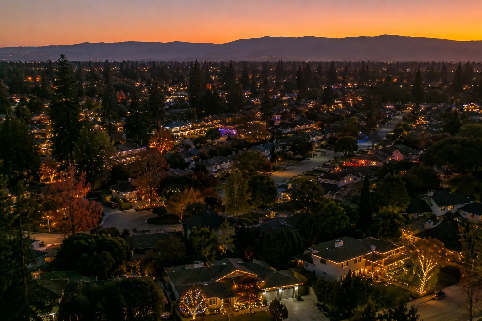 Silicon Valley neighborhood lit with Christmas lights at dusk